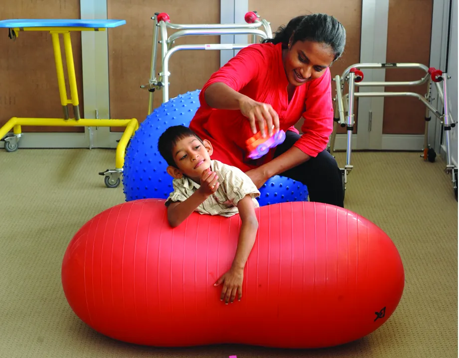 a woman interacting with a kid with disability at the MJF Centre